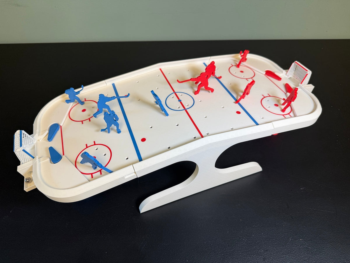 White tabletop hockey rink with red and blue players