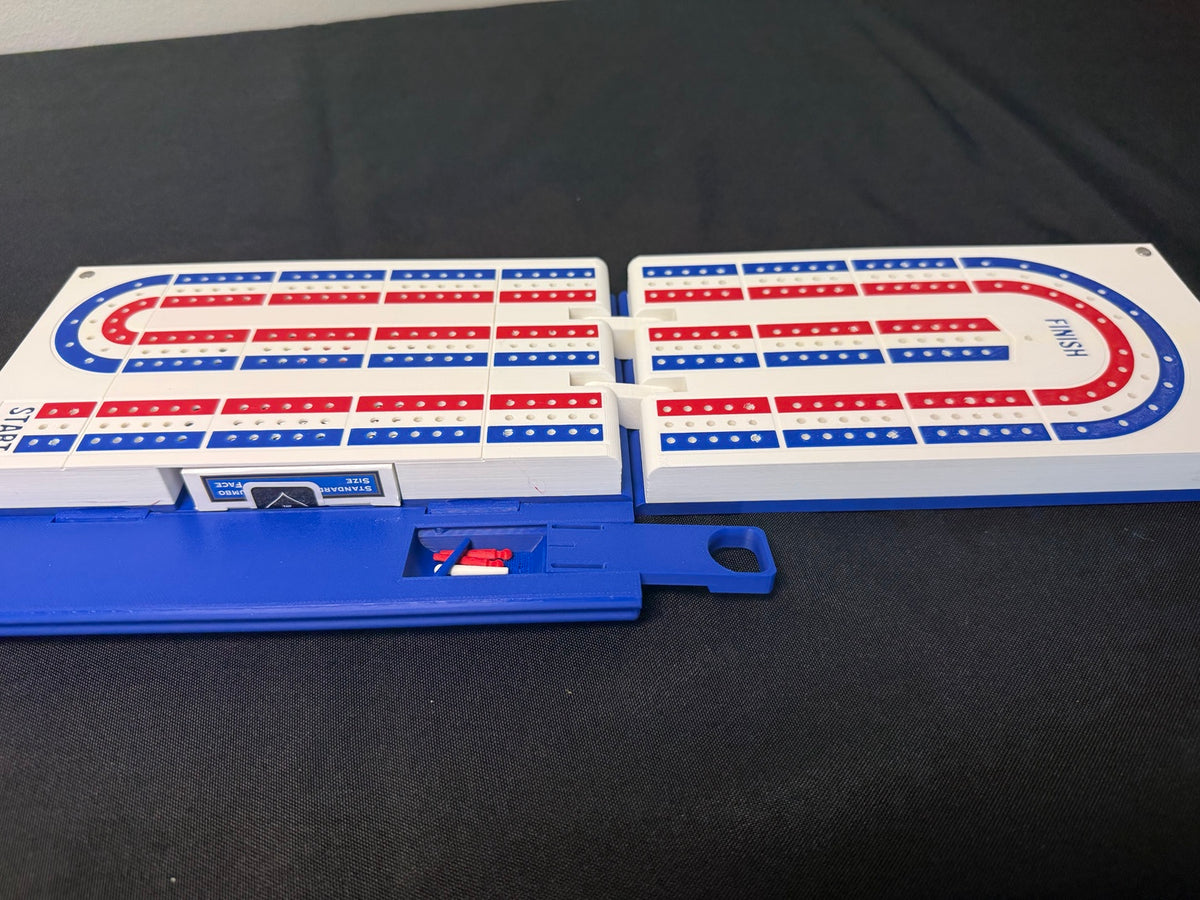 Blue book-style cribbage game opened with red and blue scoring tracks