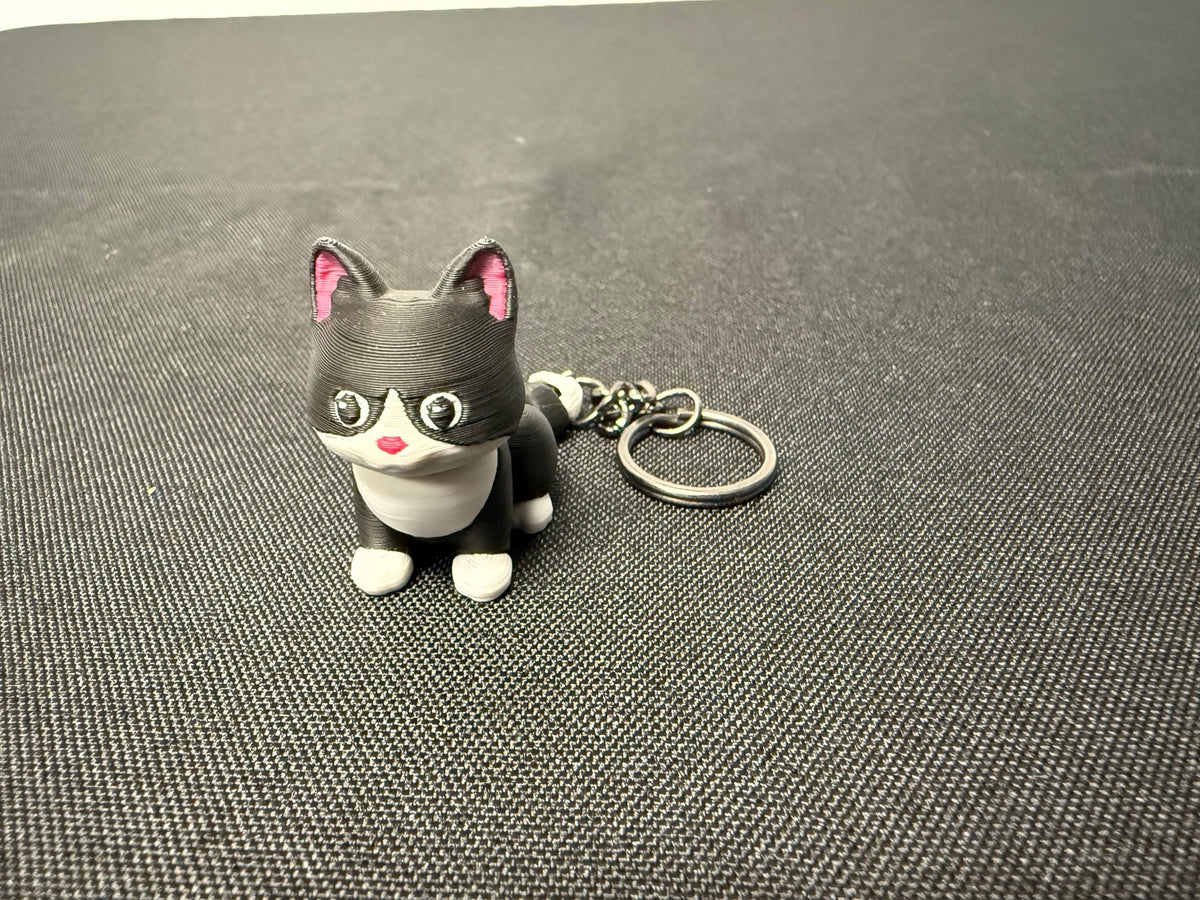 Black and white articulated cat keychain