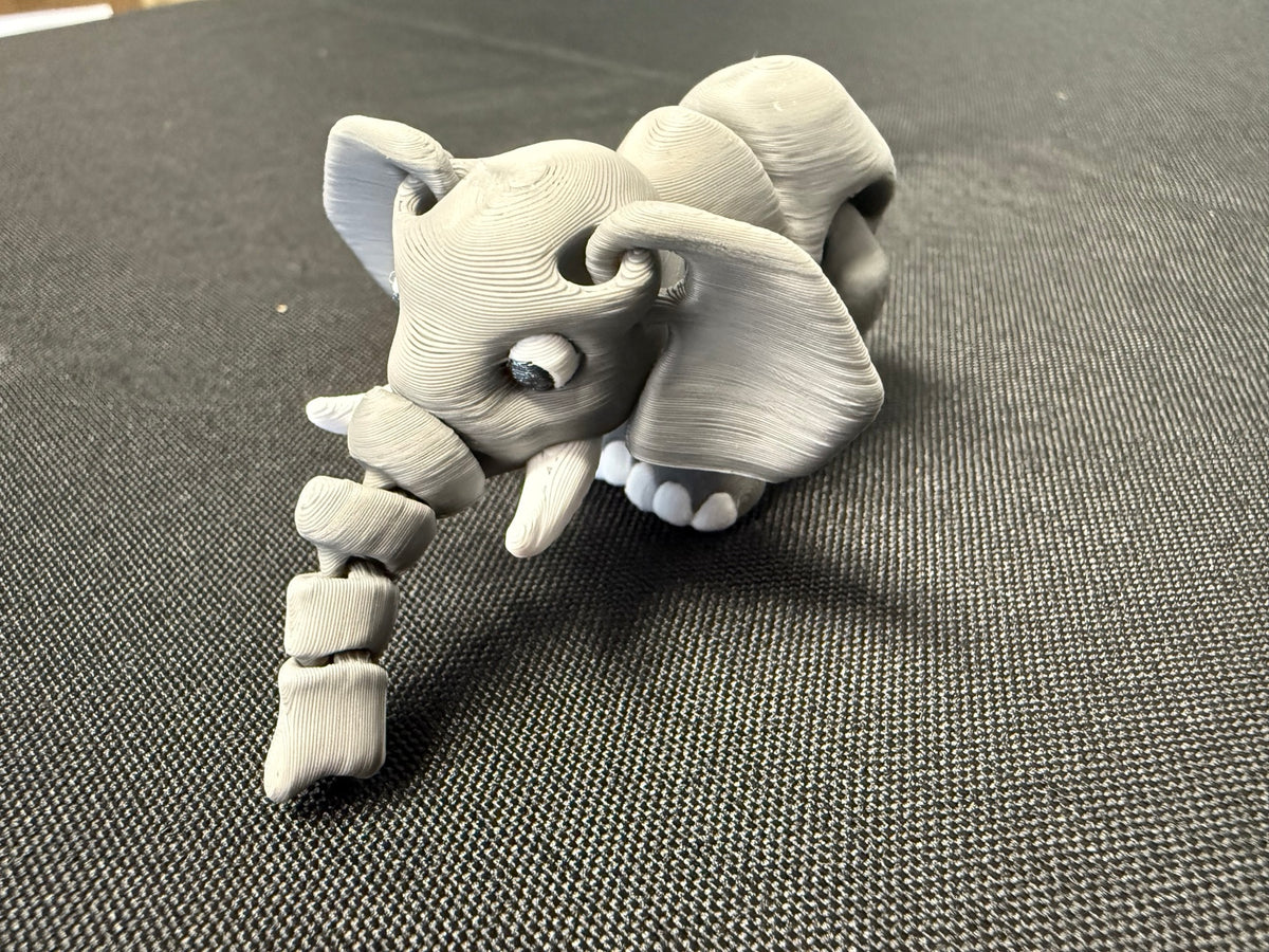 Gray articulated elephant with segmented trunk