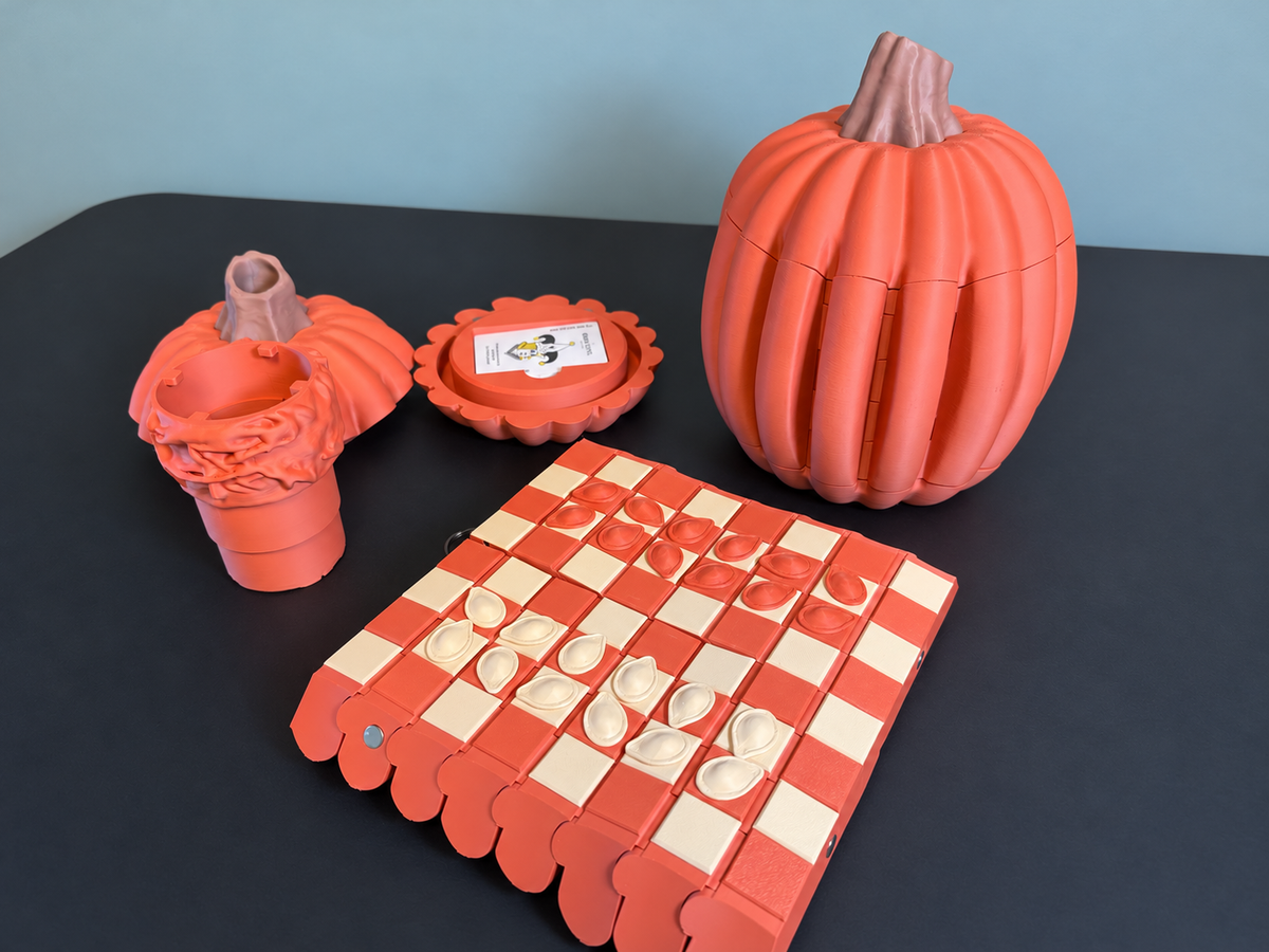 Gourd Games pumpkin set with checkers board, dice roller and card storage on a clean charcoal table