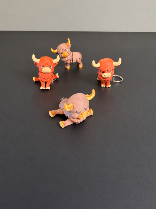 Articulated Highland cow keychains in orange and brown finishes