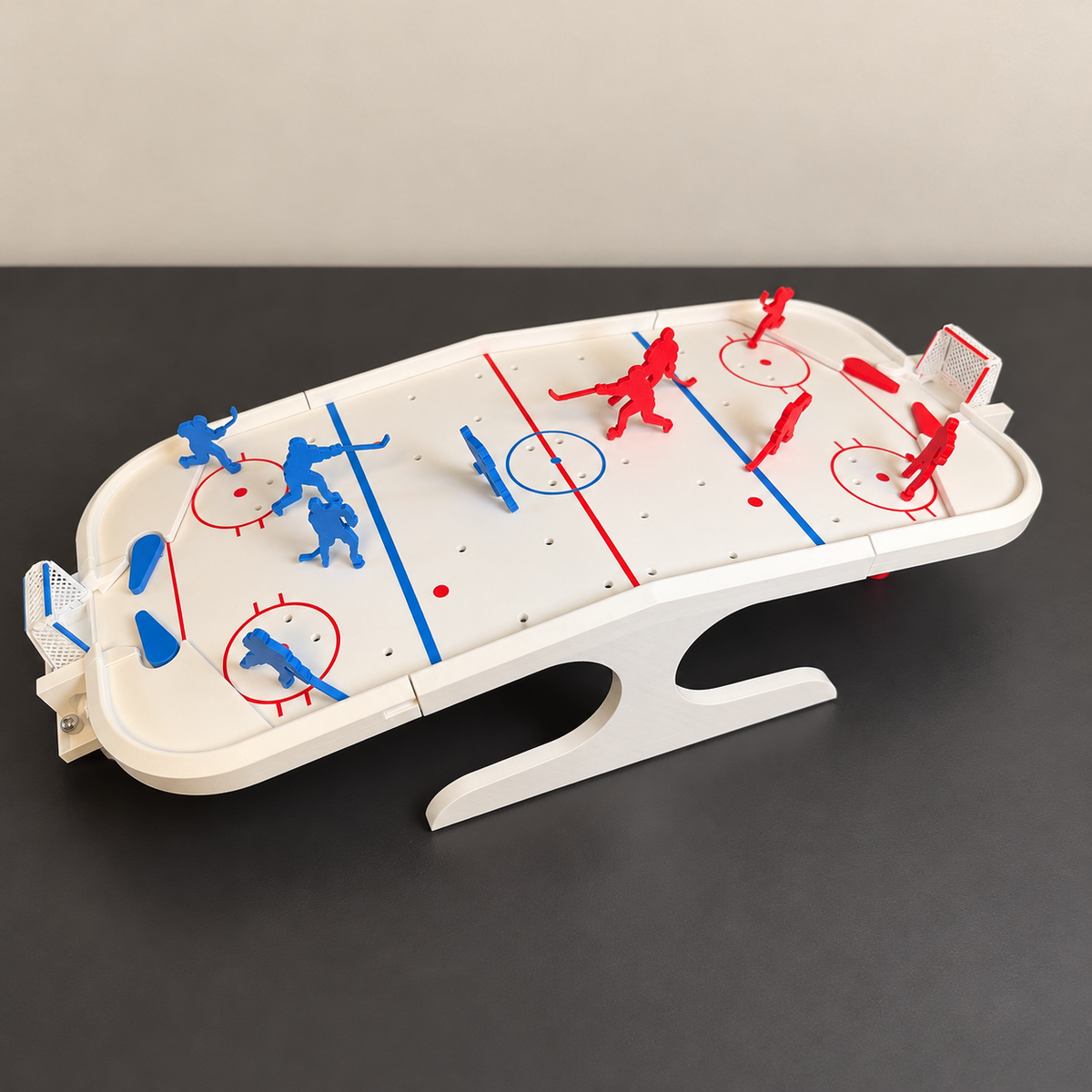 White tabletop hockey game with red and blue players