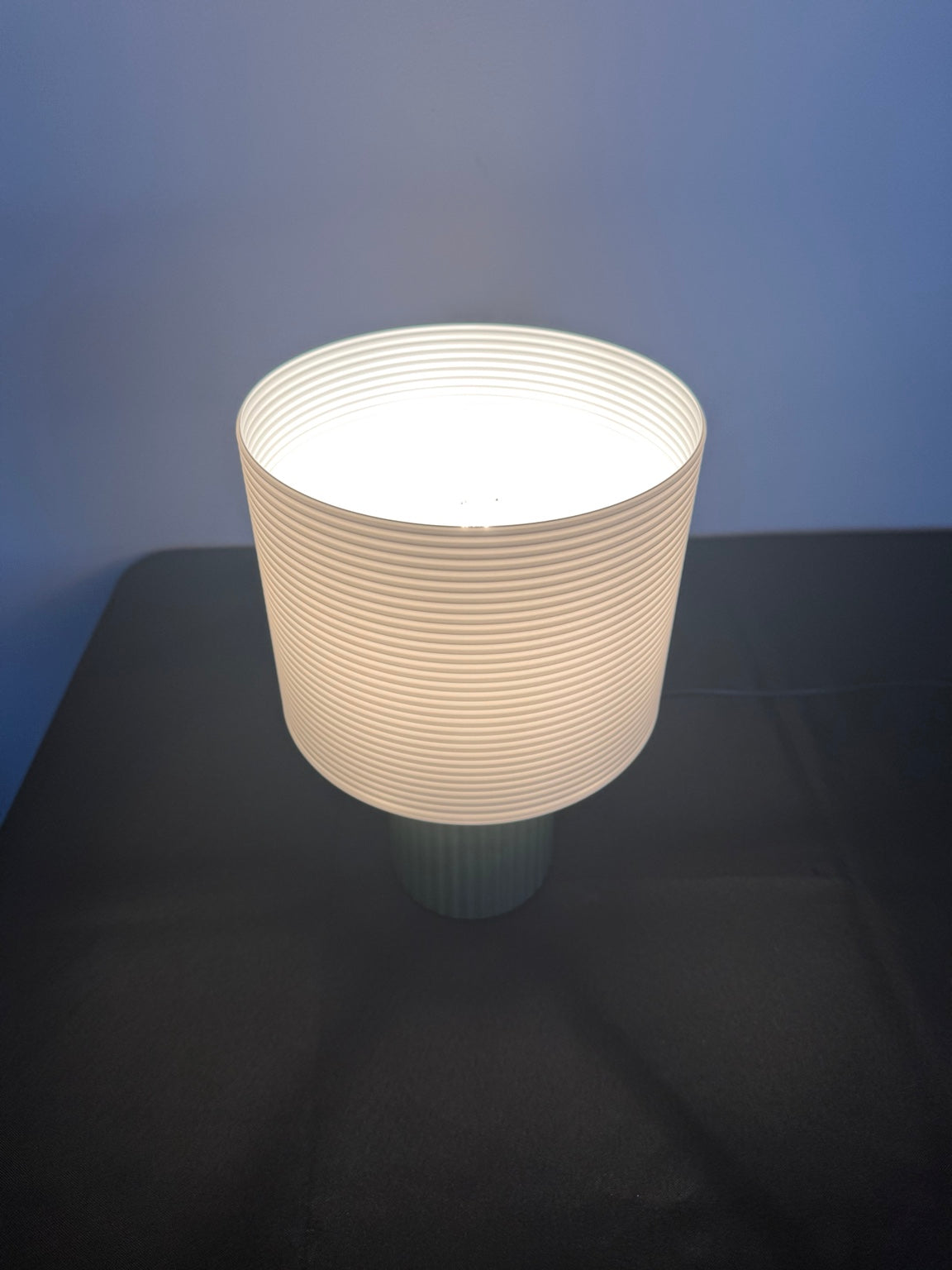 Illuminated ribbed table lamp viewed from above