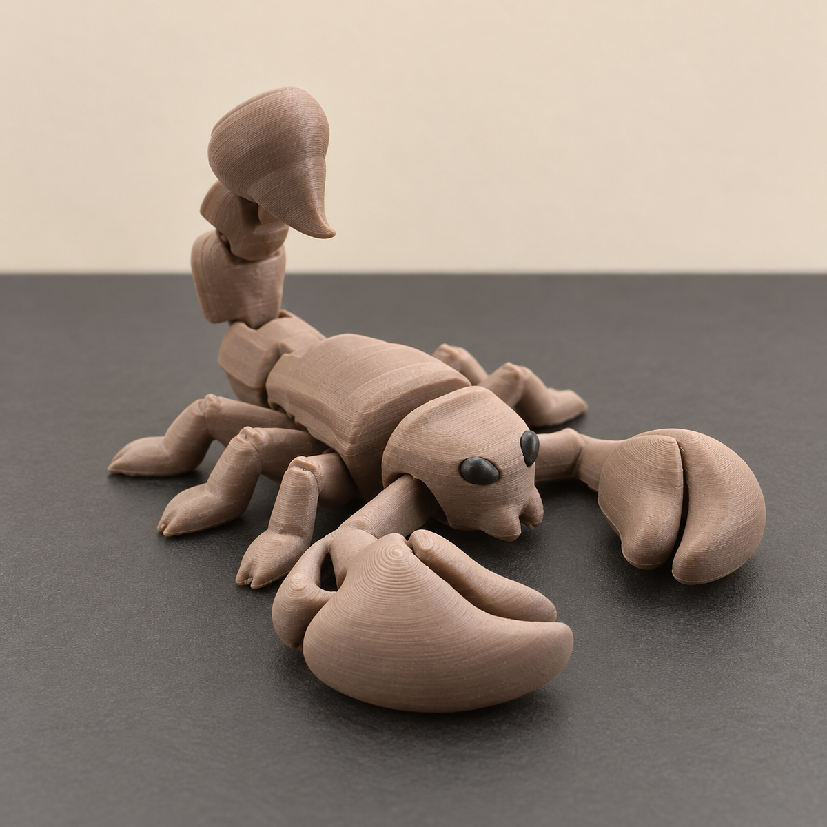 Taupe articulated scorpion with raised segmented tail