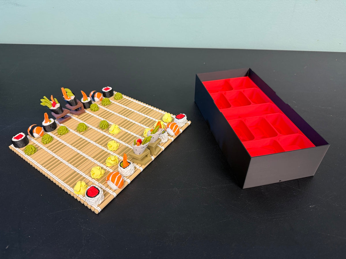 Sushi chess set beside its open red compartment storage box